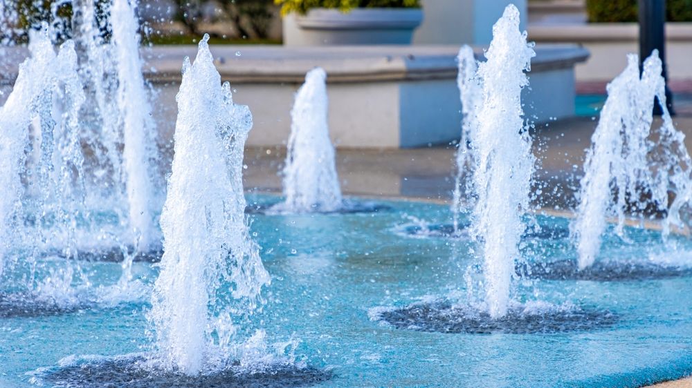Splash-pad fountains jetting up from a plaza