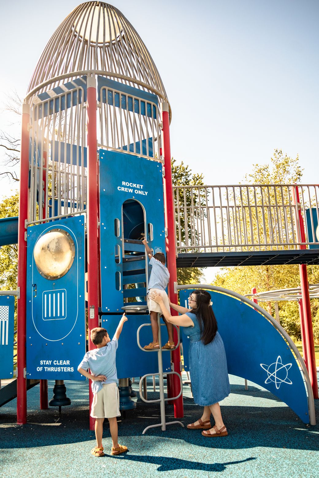 Jennifer and her kids playing on the rocket-ship playground in the Tullahoma area