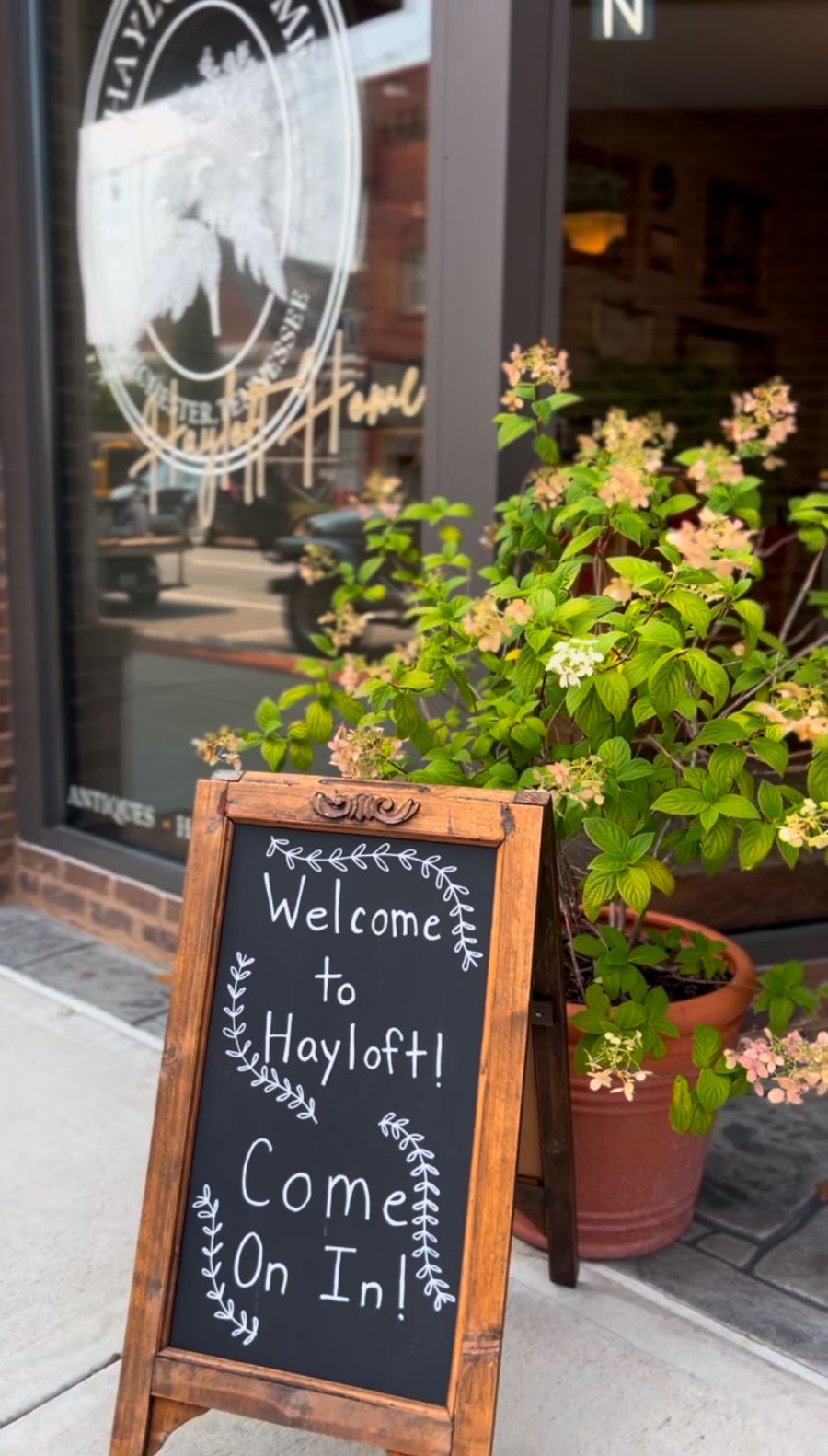 Hayloft Home storefront in Winchester with a chalkboard sign that says Welcome to Hayloft! Come on in!